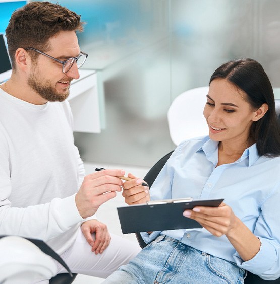 A dentist explaining dental fees to a patient