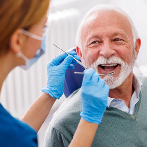 Man smiles at dentist