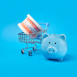 a piggy bank next to a teeth model