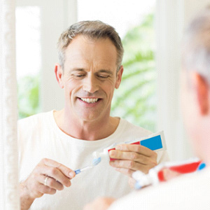 a dental patient brushing their teeth 