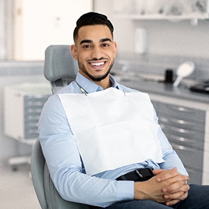 Patient smiling while sitting in treatment chair