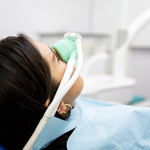 Woman breathing in nitrous oxide in treatment chair