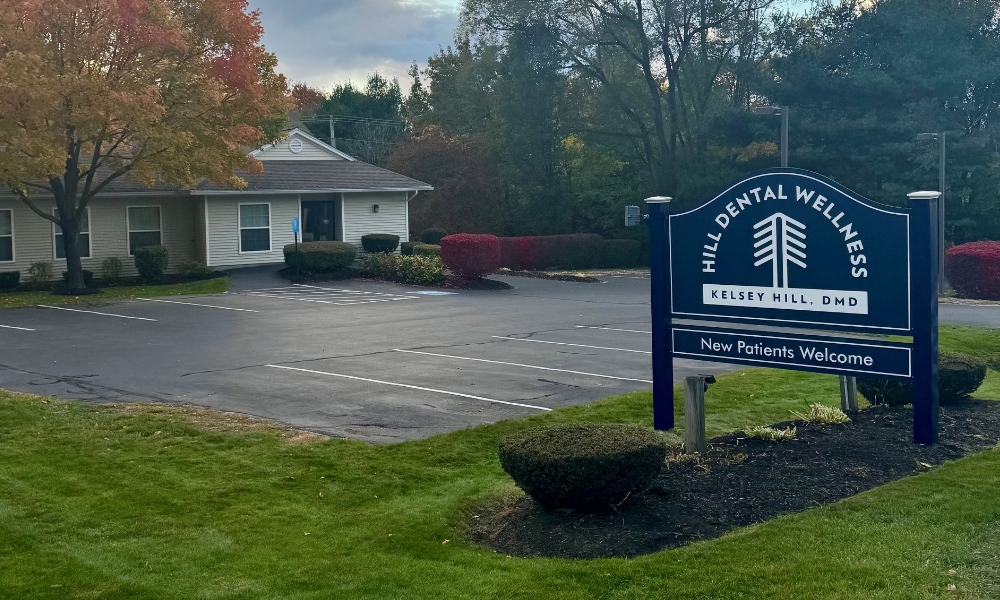 Hill Dental Wellness sign at the entrance to the parking lot of dental office in Falmouth