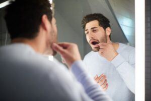 Man looking in his mouth for a gum bump