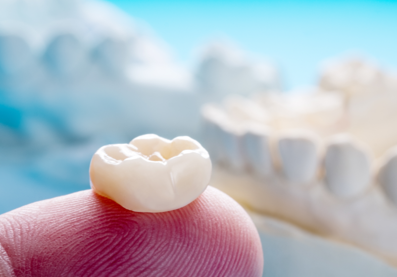 Dental crown on fingertip